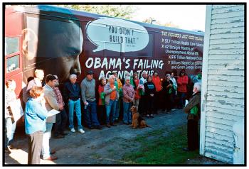 FREEDOM – Residents of Freedom and nearby towns listen to activist Dan Remian during a rally by Americans for Prosperity in front of the Dirigo Grange. The conservative political advocacy group brought its East Coast tour bus through Maine last week.