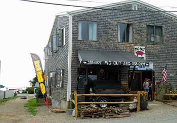 The relatively hidden location of Pig Out BBQ on Marshall Wharf may see a lot more foot traffic with the construction of the Belfast Harbor Walk, slated to follow the dirt path visible to the left of the restaurant. (Photo by Ethan Andrews)
