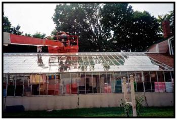 BELFAST – Workers restore the Cedar Street greenhouse that served a succession of florists. The building is now a private residence.