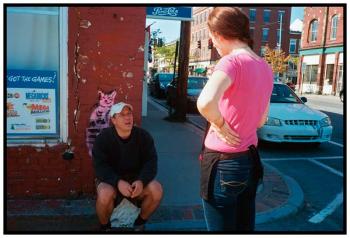 BELFAST – Lauren Smith, a waitress at La Vida, foreground, chats with upstairs resident Philip Golgano outside the restaurant during her break.