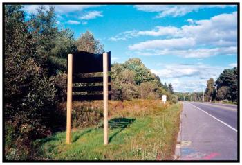 BELFAST – One of a number of new signs put up by the city this year to draw visitors into the downtown. At the Searsport town line, an old, white-backed "Welcome to Belfast" sign is visible in the distance.