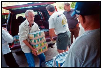 BELFAST – Volunteers outside Belfast Center unload cases of surplus canned goods from the USDA to be used in the Belfast Soup Kitchen.
