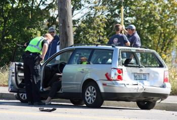 A Rockland police officer talks to the driver of the Volkswagen station wagon, which was struck from behind by a pickup truck Sept. 27 on Camden Street, in Rockland. (Photos by Holly Edwards)