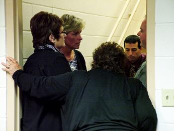 Supporters counsel Mount View Middle School teacher Eileen Ellis, second from left, during a break in a closed door session of the RSU 3 school board dealing with a grievance she filed in the spring. Ellis alleges that "bullying" by an employee ultimately forced her to take a stress-related medical leave of absence. The board heard a second grievance the same evening from teacher Ron Simmons, who cited similar treatment in his decision to switch jobs in the district. (Photo by Ethan Andrews)