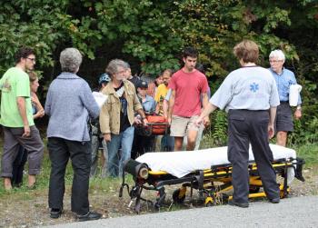 Maria Millard of Belfast is brought off the mountain along Route 52, near Barrett's Cove, in Camden late Tuesday afternoon. (Photo by Holly S. Edwards)