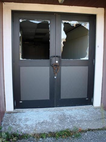 Shattered windows of a back door to MacDougal School in Rockland. (Photo by Holly S. Edwards)