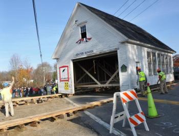 Pipe rollers and a wooden track combined block and tackle, rope and people-power to pull the old schoolhouse across the road in Lincolnville Center Saturday morning. (Photo courtesy Barbara Hatch)