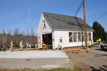 The old schoolhouse moves onto its new foundation in Lincolnville Center. (Photo courtesy Barbara Hatch)