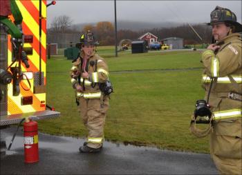 Rockland firefighters Katie Vanorse and Rusty Barnard inspect the jail for the source of smoke in the booking area. (Photo by Lynda Clancy)