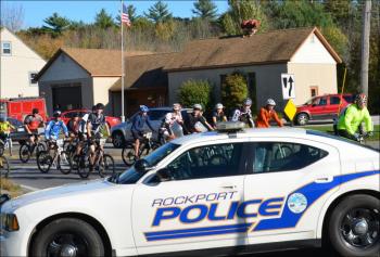 The Camden Hills Regional High School bike team came by as traffic continued to be rerouted.