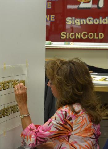 Carla Quinn has been with Pierce for 34 years and she gilds the letters with 24-carat gold. (Photo by Lynda Clancy)