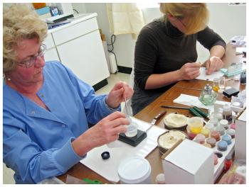 Ottie Thomas-Smith, left, works alongside apprentice Lily Cross. (Photo by Ethan Andrews