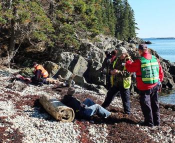 Search and rescue crews evaluate 'victims' during Saturday's mass casualty exercise, under the watchful eyes and ears of evaluators. (Photo by Holly S. Edwards)