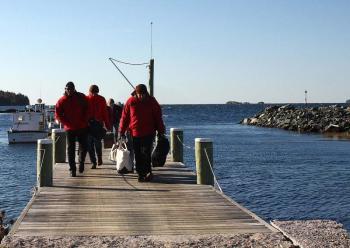 Landing on Lasell Island, radio communications operators and volunteer 'victims' head to shore to their assigned positions for the mass casualty drill Oct. 13. (Photo by Holly S. Edwards)