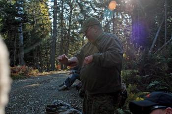 Another volunteer victim gets a fresh dose of fake blood before climbing down into a 5-foot-deep hole to await 'rescue' in the Lasell Island exercise Oct. 13. (Photo by Holly S. Edwards)