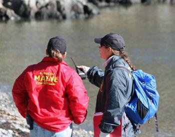'Victim wrangler' Ellie Adams, left, and Search and Rescue Evaluator Aliesha Black talk about what's happening on the beach between the volunteer victims and their rescuers. (Photo by Holly S. Edwards)