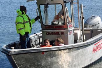 Other 'victims' are rescued off the beach at Lasell Island via the Rockport Harbormaster's boat. (Photo by Holly S. Edwards)