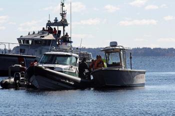 Volunteer 'victims' are moved from boat to boat Saturday during the mass casualty drill on Lasell Island. (Photo by Holly S. Edwards)