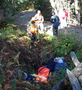 Rescuers discover two more victims in a hole south of the beach where eight other victims from a hypothetical plane crash were discovered. (Photo by Holly S. Edwards)