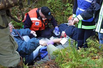 One of the volunteer 'victims' in the hole was complaining of hypohthermia and stiff joints while the other was suffering a compound leg fracture. (Photo by Holly S. Edwards)