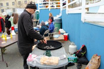 Paul Finden grills up some dogs.