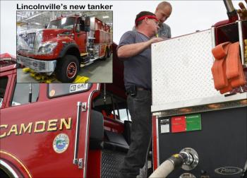 Camden firefighters Robert Stiehler and Cheyne Hansen test the systems on the department's 1981 Pierce-built truck in September. (Photo by Lynda Clancy)