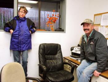Belfast Transfer Station's newly-hired manager Sandy Carey, left, and longtime operator Steve Roberts enjoy a quiet moment. With the arrival of a new plastics baler that will expand the facility's recycling program, they're expecting to be unusually busy in the coming months. (Photo by Ethan Andrews)
