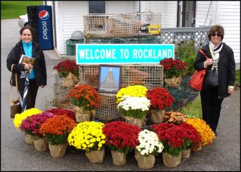 Phyllis Schwartz and Elayne Kollins, of Las Vegas, and The World residents pose beside the welcome to Rockland sign.