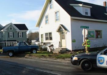 Christopher Prescott's pickup truck beside the Puddleducks Thrfit Boutique building Monday after the crash. (Photo courtesy Rockland Fire Department/by Alan Athearn)