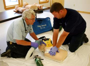 Justin Hills practices CPR with Bill Bentley at Camden First Aid Association. (Photo by Holly S. Edwards)