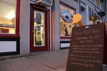 A sign outside the Chocolate Drop Candy Shoppe advertises Early Bird deals. (Photo by Wes Sterrs)