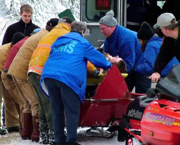 Justin Hills, in gray knit cap, at the scene of a snowmobile accident off Route 52 in Lincolnville. (Photo by Holly S. Edwards)