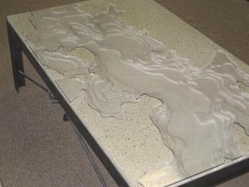 A topographical map of islesboro etched into a concrete coffee table. (photo: Alternative Rock, LLC) alternative rock, llc, pechakucha