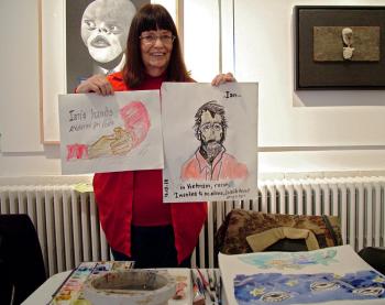 Suzanna Lasker of Jefferson holds up two portraits she painted of Vietnam veteran Ian Collins of LIberty painted during an Armistice/Veterans Day draw-a-thon at Waterfall Arts. (Photo by Ethan Andrews)