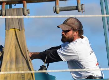 Justin Kaler carefully guides the Kiwi Spirit toward the water before lowering her in the Travel Lift into the tide.