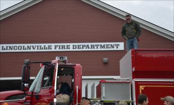 Mike Eugley gets perspective from the roof. (Photo by Lynda Clancy)
