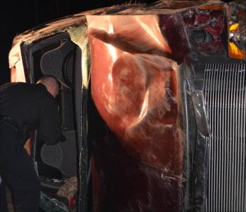 Knox County Sheriff's Sgt. Michael Sprague investigates the overturned truck. (Photo by Lynda Clancy)