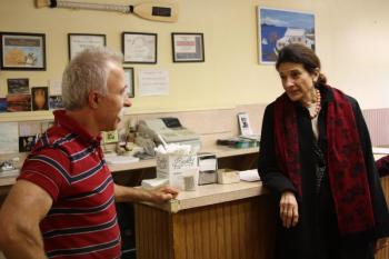 Uncle Jeff, proprietor of Camden House of Pizza, chats with Maine Sen. Olympia Snowe about politics and pizza Nov. 1. (Photo by Holly S. Edwards)