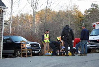 Lincolnville firefighters assist Camden First Aid Association personnel at the scene of a crash at 367 Slab City Road Monday afternoon involving a car, a parked pickup truck and a house. (Photo by Holly S. Edwards)