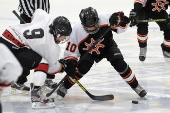 MCSA Storm's player, left, wins the face off with Casco Bay's Marcus Cady during Sunday's game at Midcoast Recreation Center in Rockport. The Storm Bantam team won 3-2. (Photo by Ron Hawkes)