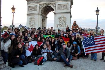 The author (just above the stars on the furthest of two American flag) poses in front of the Arc de Triomphe with fellow travelers on a Rotary-organized trip from Belgium to Paris.