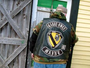 Dwayne Keller of the Garry Owen Motorcycle Club opens the front door of the old Montville farmhouse he and other club members are renovating as a shelter and advocacy center for veterans. (Photo by Ethan Andrews)
