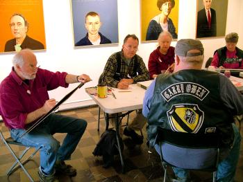 Dwayne Keller, foreground, a Vietnam War veteran, sits for portraits by artists, from left, Robert Shetterly, Kenny Cole and Charlene Decker during an Armistice/Veterans Day draw-a-thon.