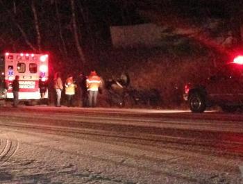 An unidentified man was trapped upside down by his seat belt after his truck overturned on slippery Route 90 in Warren Wednesday evening. (Photo by Lynda Clancy)