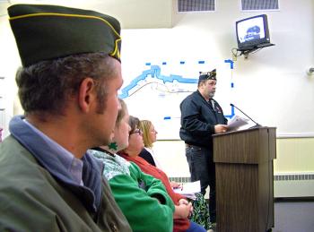 Veteran Timothy Parker, at the podium, was one of a number of residents who came to City Hall on Tuesday night to speak out against the idea of putting creative lighting and seating on the footbridge, officially known as the Armistice Bridge. (Photo by Ethan Andrews)
