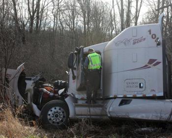 Rockport Police Officer Dana Smith talks to the driver of the tractor trailer, Ronald Goguen of New Brunswick. (Photo by Holly S. Edwards)