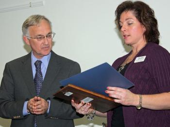 Hutchinson Center staff member Andrea Rouillard presents an award to Lee Woodward of Belfast Rotary Club. (Photo by Holly S. Edwards)