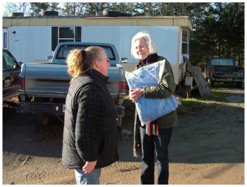 Linda Gillies, right, brings a tarp to Laura Houle at Houle's tagging station. Both Houle and Gillies served on committees over the last several years that studied the island's problem with Lyme disease. (Photo by Ethan Andrews)