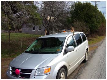 Among the unknowns of the special hunt is how easy the deer will be to find in December when they may be settling in for winter. Here, an island mail delivery car sports seasonal reindeer antlers and a red nose. (Photo by Ethan Andrews)