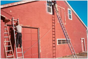SEARSPORT - Peter Taliaferro, left, and Brad Buttrick of the two-man painting company The Classic Brush, spruce up the facade of the new Sundog Solar Store a week before the company moved to the new building, a mile-and-a-half up Route 1 from its original downtown location.
